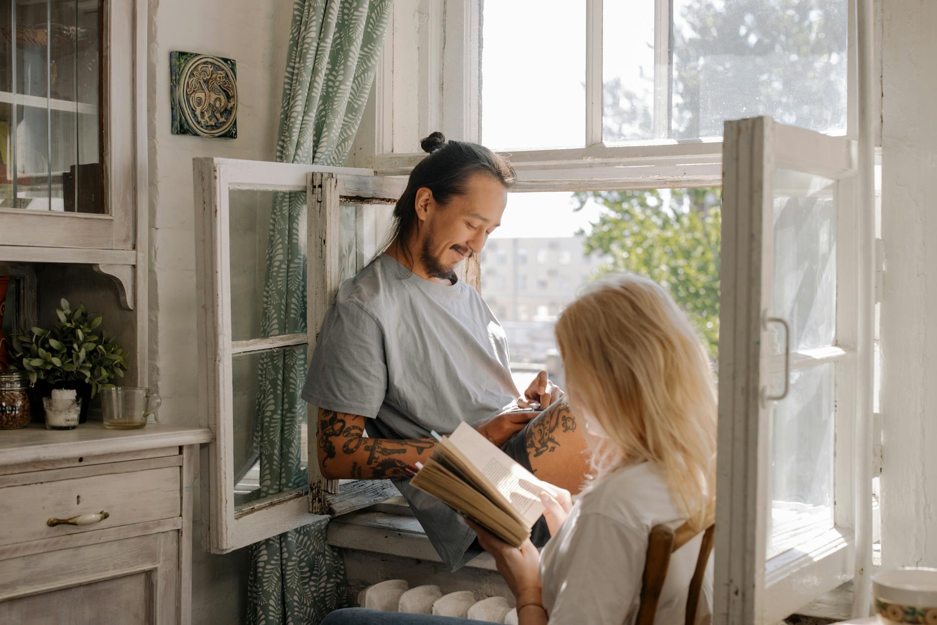 woman in gray long sleeve shirt reading book