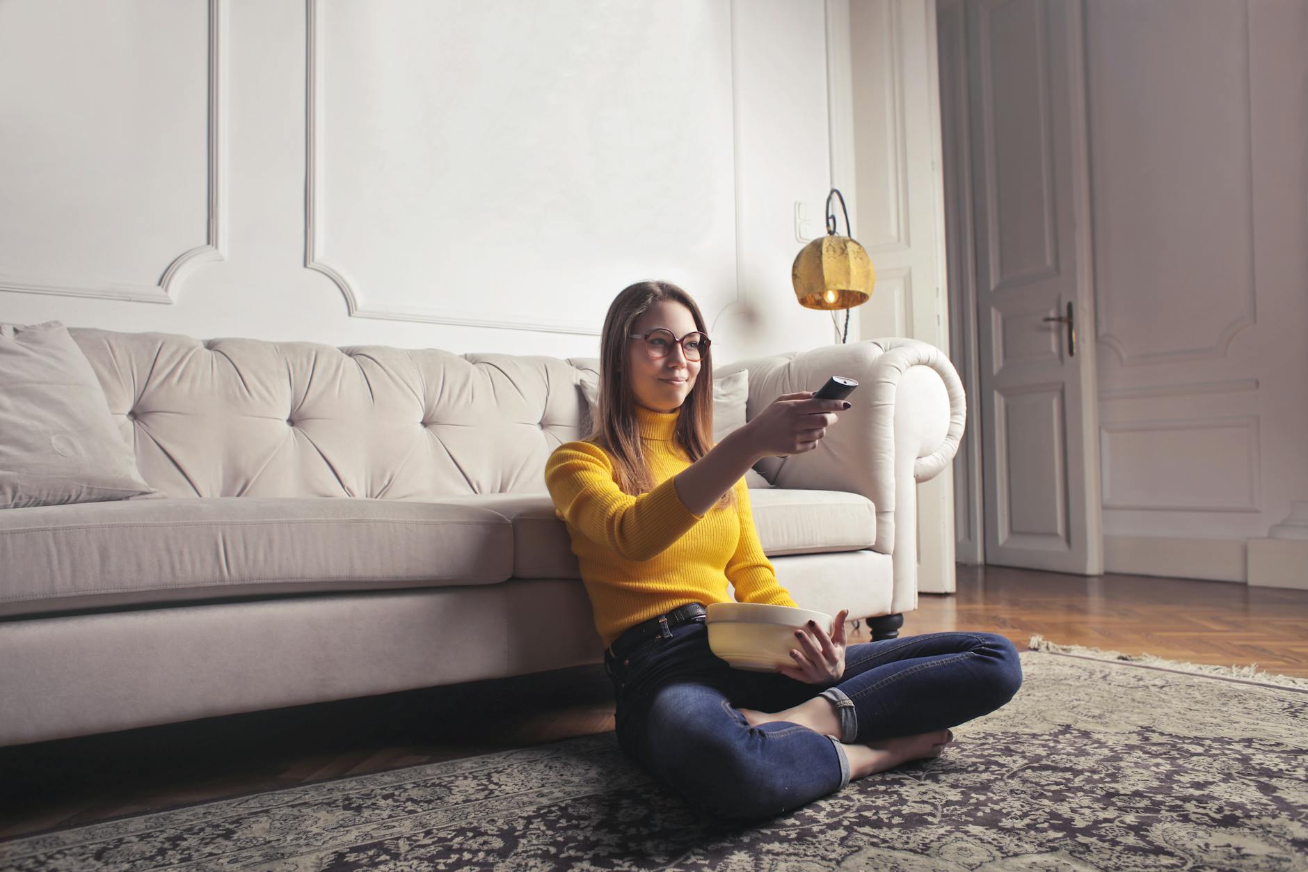 young woman relaxing at home and watching movie