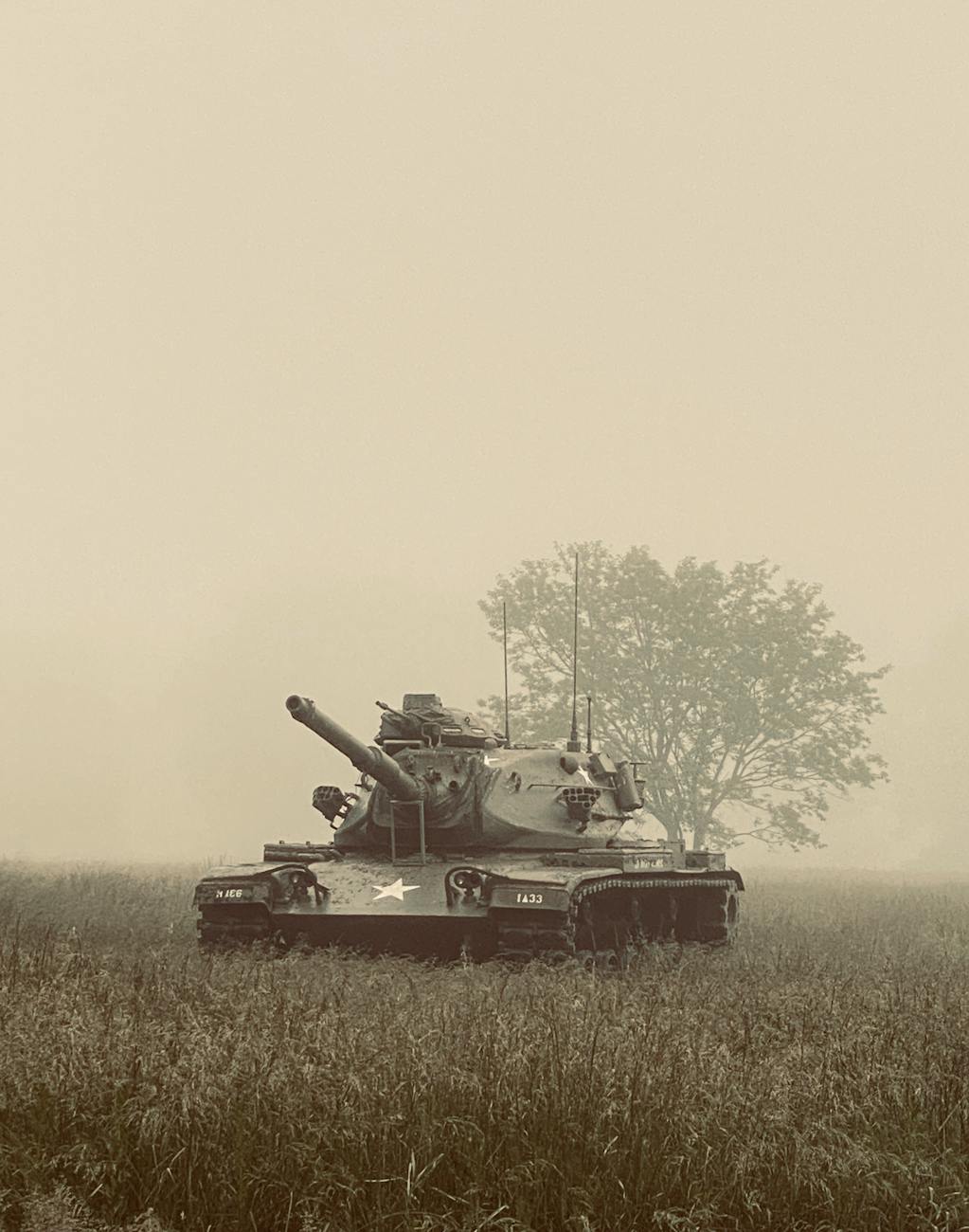 green battle tank on green grass field